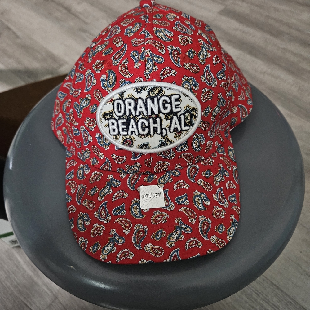 Orange Beach, AL baseball cap red with designs on it. Alvin's Island (A-44)